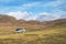 Achill, IRELAND - OCTOBER 10, 2022: A VW camper T5 parking in front of a mountain face in the Irish coast. Green meadows and trees