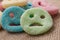 Acidulous candies in shaped smiley on hessian backgro