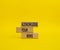 Acknowledge your wins symbol. Concept words Acknowledge your wins on wooden blocks. Beautiful yellow background. Business and