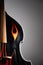 Acoustic double bass with flames decals, close-up view.