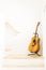 Acoustic or folk guitar is placed on a stand between the stair corridors of the house or apartment with copy space in portrait