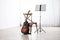 Acoustic guitar, chair and note stand with music sheets