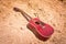 Acoustic guitar lying on a  desert land, vintage style with copy space