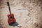 acoustic guitar lying on a desert land, vintage style with copy space