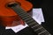 Acoustic guitar with music sheets