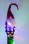 acoustic guitar with red Santa hat and light colorful garland. Christmas music concept