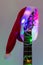 acoustic guitar with red Santa hat and light colorful garland. Christmas music concept