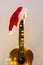 Acoustic Guitar with red Santa hat and light garland. Christmas music song concept with copyspace