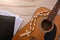 Acoustic guitar with religious songbook on wooden table top view