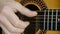 Acoustic Guitar Strumming. Close-up of a hand strumming classical guitar.