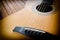 Acoustic guitar on a wooden background with copy space.The guitar is a fretted musical instrument that usually has six strings