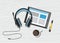 Acoustic headphones with tablet and coffee on white wooden background