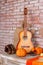 Acoustic orange guitar in the fall season.seasonal offers and holiday post card.Autumnal decoration.Autumnal decoration