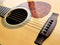 Acoustic wood guitar close up on wooden background with fretboard, strings, and tuners for music blogs, musician social media.