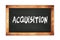 ACQUISITION text written on wooden frame school blackboard