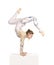 Acrobat doing gymnastics, a young circus artist in a white and blue suit, performs acrobatic elements