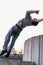 Acrobat man training parkour exercise while jumping backflip