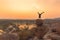 An Acrobat performs a hand stand at the spectacular sunset point at Hampi in Karnataka, India