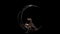 Acrobat rotating design in the form of a moon. Black background. Slow motion