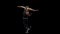 Acrobat in a sparkling costume rotates on a moon in a string. Black background. Slow motion