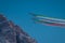 Acrobatic group of Freccia trecolori jet aeroplanes are performing maneouvres in a formation in the italian dolomites close to