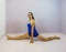 Acrobatic gymnastics side split on the floor skill preformed by a young transgender girl