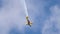 An acrobatic plane, flying in the blue sky with white clouds, doing acrobatics