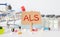 the acronym als for Amyotrophic Lateral Sclerosis concept represented by wooden letter.