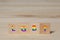 Acronym lgbt written on wooden block and colors of peace flag with copy space