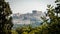 The Acropolis and Parthenon framed by trees and Herodes theater