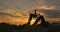 Acroyoga concept. Two sporty people practicing yoga in pair on nature sunset background. Beautiful young couple doing