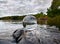 Acrylic crystal ball on rock by a lake