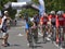 Action scene during the race, with a cyclist asking for water, during Road Grand Prix event, a high-speed circuit race