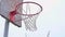 Action shot of basketball going through basketball hoop and net