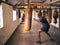 Action Shot Of Male Boxer In Gym Training With Leather Punch Bags