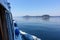 Action shot from the point of view of a person viewing from inside a boat, as it moves across the ocean with beautiful islands