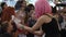 Action with smoke for childrens at mall on celebration halloween, girl in pink wig with boiling glass flask