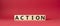 Action symbol. Concept word Action on wooden cubes. Beautiful red background. Business and Action concept. Copy space