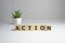 Action word written on wood block. Action text on table, concept