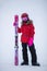 Active adorable preschooler caucasian girl portrait with ski in helmet, goggles and bright suit enjoy winter extreme sport