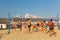 Active adults play the sport of volleyball on the sand beach