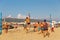 Active adults play the sport of volleyball on the sand beach