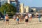 Active adults play the sport of volleyball on the sand beach