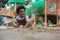 Active African little boy afro hair enjoy playing outdoors, Happy 3 Years kid having fun with sand and his toys on playground in t