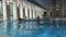 Active aging couple swimming in indoor hotel pool