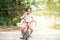 Active Asian child riding bicycle outdoor.