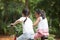 Active Asian children riding bike outdoor.