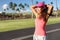 Active Asian runner woman tying hair into ponytail getting ready to run her morning jogging workout. Happy healthy