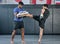 Active, athletes and fit men kick boxing and doing sport training workout in a gym. Two male partners or MMA boxer and