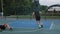 Active athletic males practicing streetball game one on one on outdoor basketball court. Close up. Slow motion.